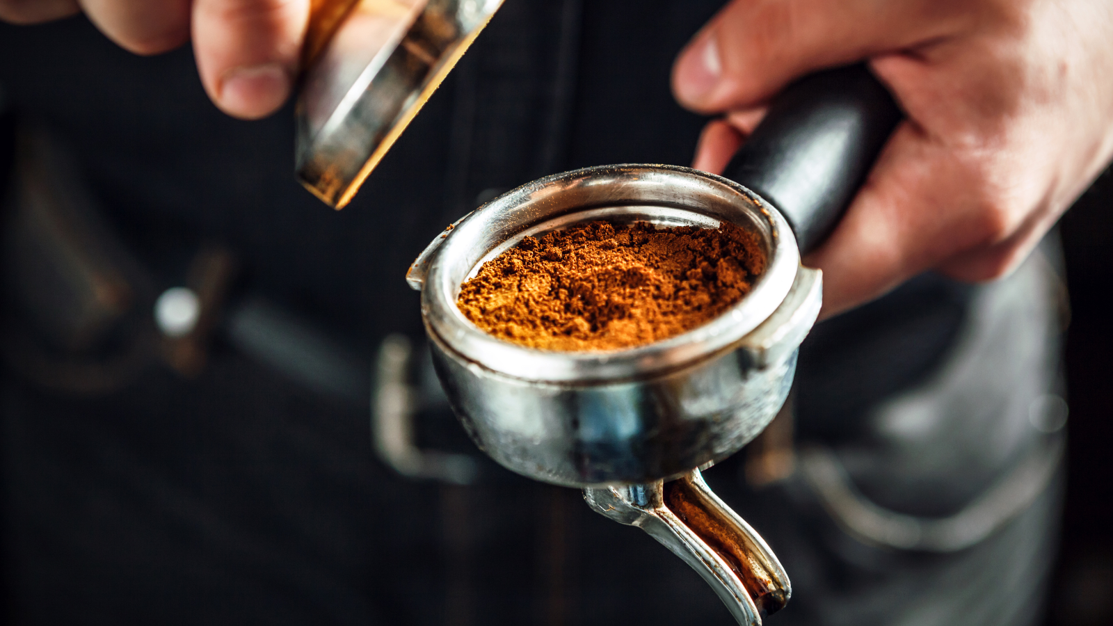 Getting ready to tamp down coffee